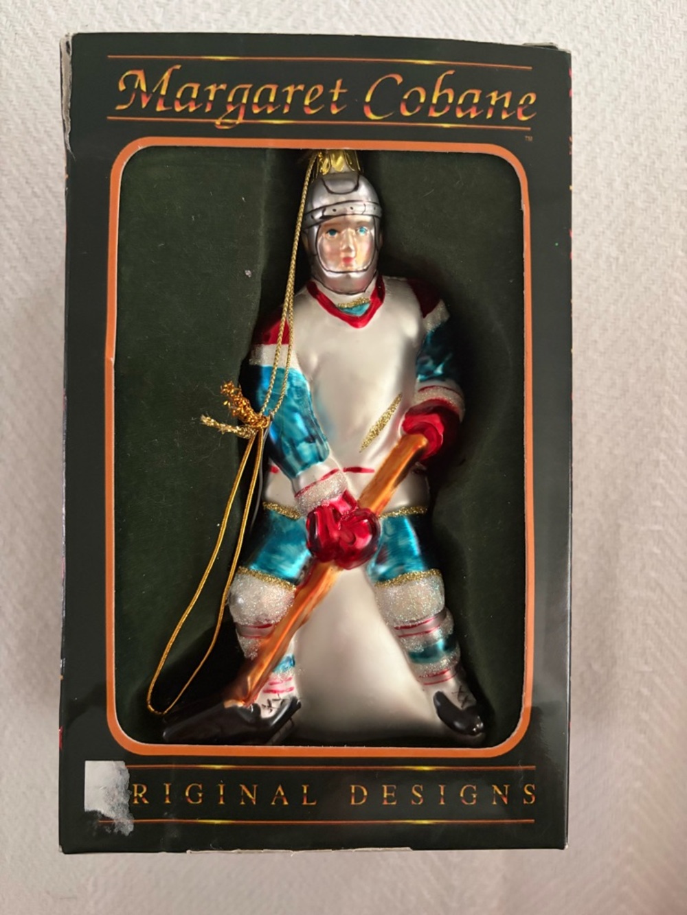 Margaret Cobane Blue and White Hockey Player Holiday Ornament